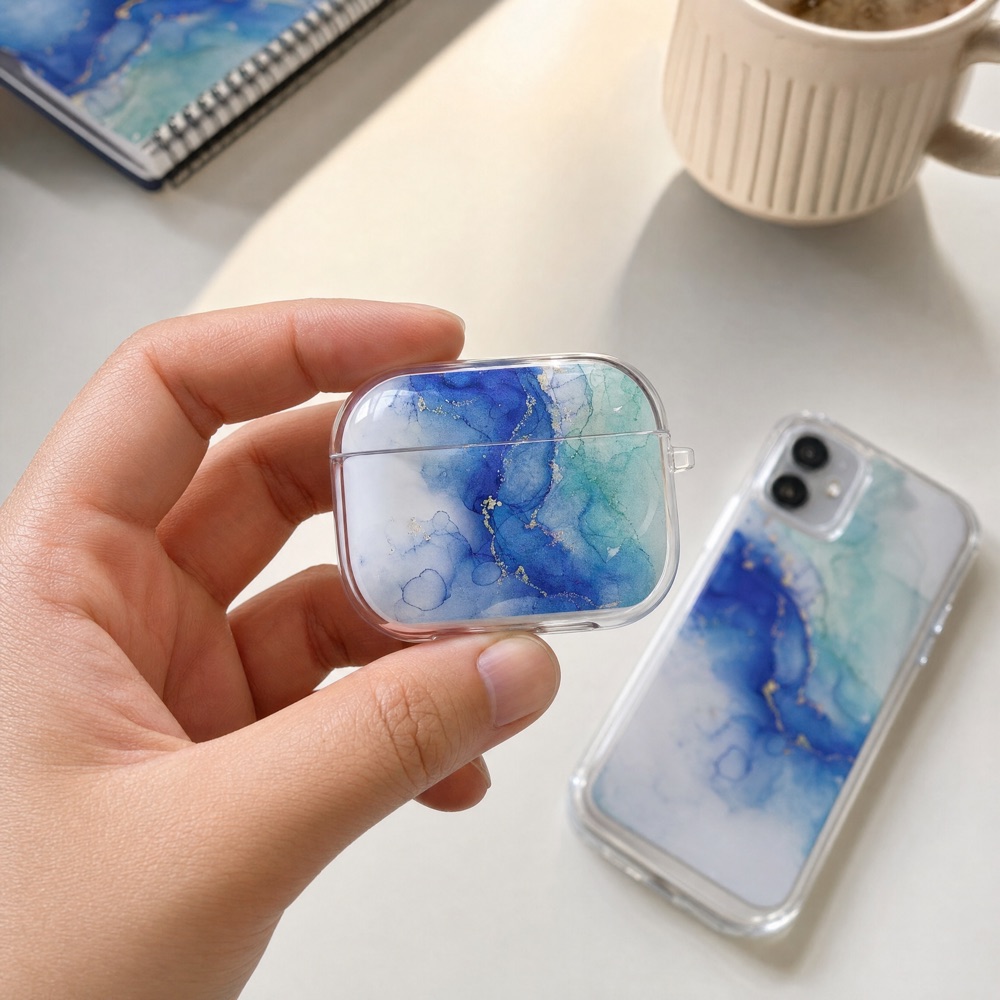 A hand holding an earbuds charging case in a transparent case printed on the front